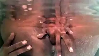 Tattooed Indian slut plays with her boobs and dark cunt underneath the water while in the bathtub